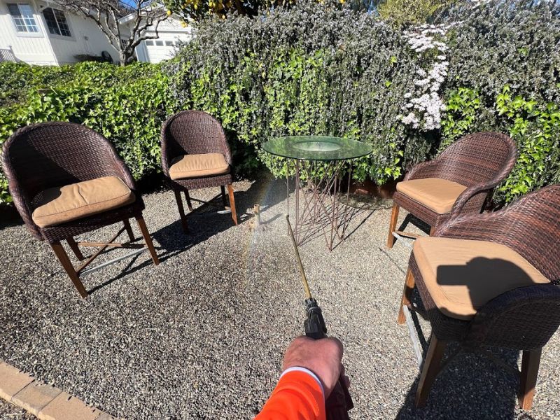 gilroy pest control man spraying chairs and table outside patio